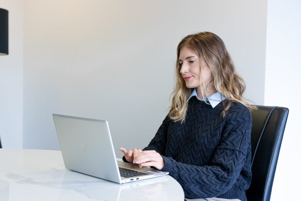 Brink team member typing at a laptop